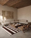 Load image into Gallery viewer, Brown and Cream striped wool rug in a furnished room

