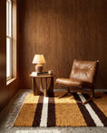 Load image into Gallery viewer, Brown, Cream and Ochre Yellow striped wool rug in a furnished room
