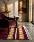 Load image into Gallery viewer, Ochre Yellow, Cream and Burgundy striped wool rug in a furnished room
