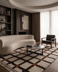 Load image into Gallery viewer, Brown, Terracotta and Cream grid wool rug in a furnished room
