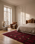 Load image into Gallery viewer, Brown, Taupe and Burgundy grid wool rug in a furnished room
