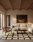 Load image into Gallery viewer, Olive Green, Ochre Yellow and Cream grid wool rug in a furnished room
