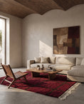 Load image into Gallery viewer, Brown and Burgundy grid wool rug in a furnished room
