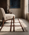 Load image into Gallery viewer, Brown and Cream grid wool rug in a furnished room
