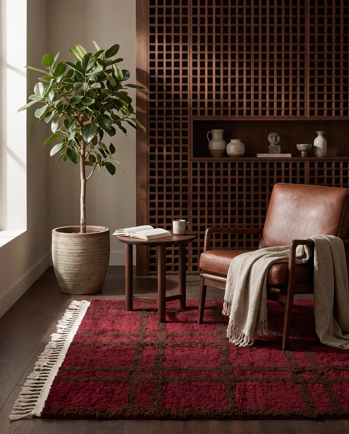Brown and Burgundy grid wool rug in a furnished room