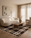 Load image into Gallery viewer, Cream and Dark Brown grid wool rug in a furnished room

