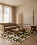Load image into Gallery viewer, Olive Green and Cream grid wool rug in a furnished room
