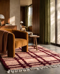 Load image into Gallery viewer, Burgundy and Blush Pink grid wool rug in a furnished room
