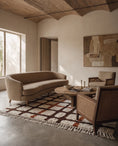 Load image into Gallery viewer, Brown, Terracotta and Cream grid wool rug in a furnished room
