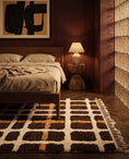 Load image into Gallery viewer, Cream, Ochre Yellow and Dark Brown grid wool rug in a furnished room
