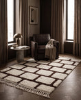 Load image into Gallery viewer, Brown and Cream grid wool rug in a furnished room
