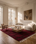 Load image into Gallery viewer, Brown and Burgundy grid wool rug in a furnished room
