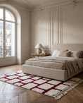 Load image into Gallery viewer, Burgundy and Cream grid wool rug in a furnished room
