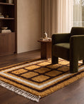 Load image into Gallery viewer, Brown, Cream and Ochre Yellow grid wool rug in a furnished room
