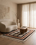 Load image into Gallery viewer, Brown, Terracotta and Cream grid wool rug in a furnished room
