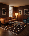 Load image into Gallery viewer, Cream, Ochre Yellow and Dark Brown grid wool rug in a furnished room
