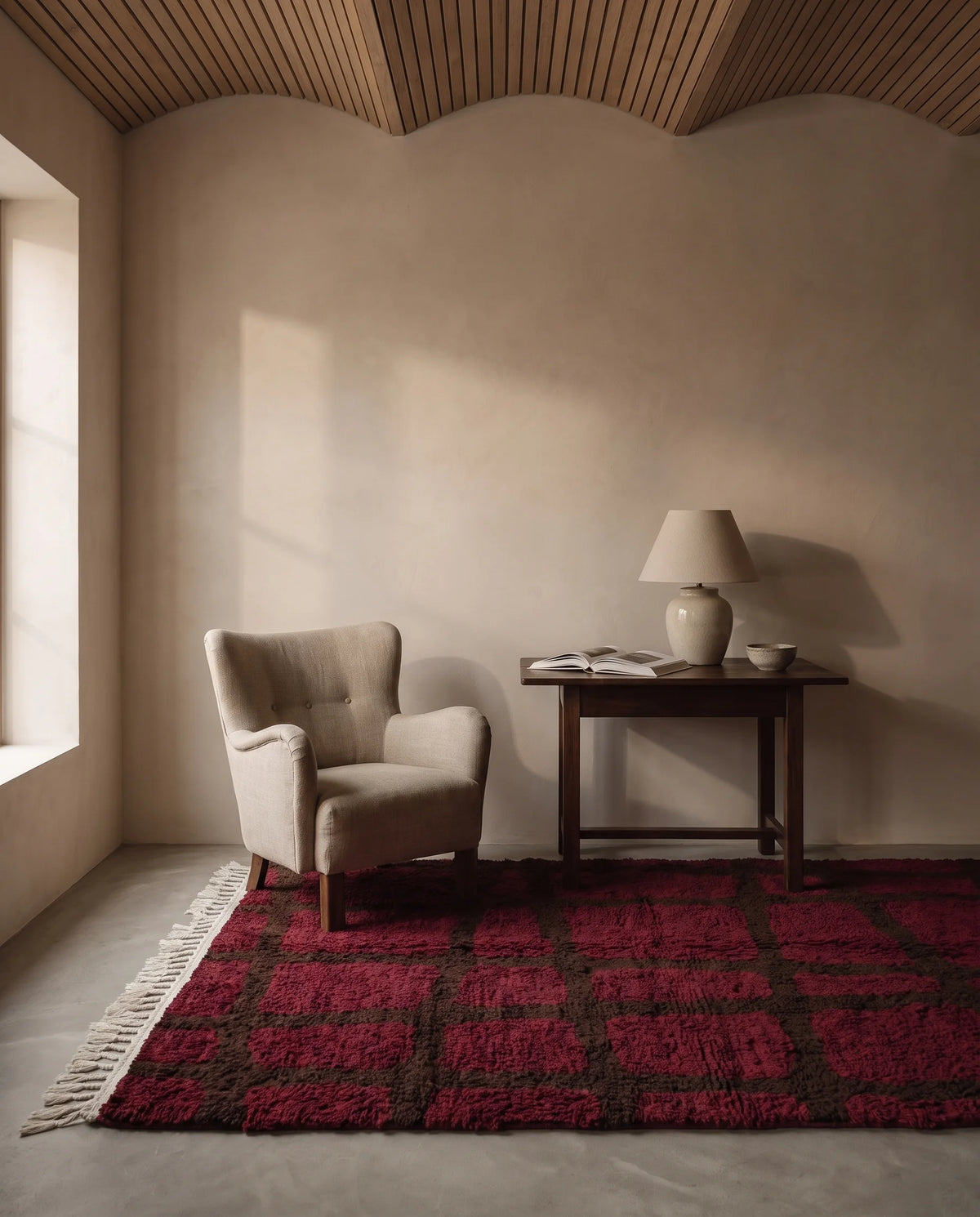 Brown and Burgundy grid wool rug in a furnished room