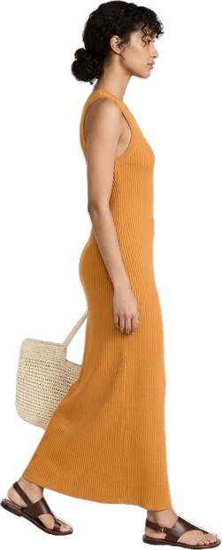Woman walking: woman with dark curly hair tied back walking to the right in side profile