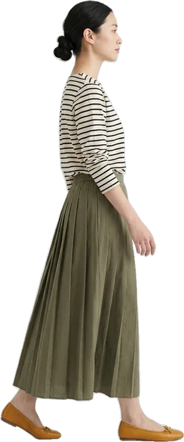 Woman walking: woman with dark hair in bun walking to the right in side profile