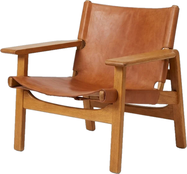 Lounge chair: mid-century lounge chair in cognac tan saddle leather slung on a bent honey-oak frame with wide 