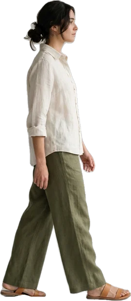 Woman walking: woman with dark hair in bun walking to the right in side profile