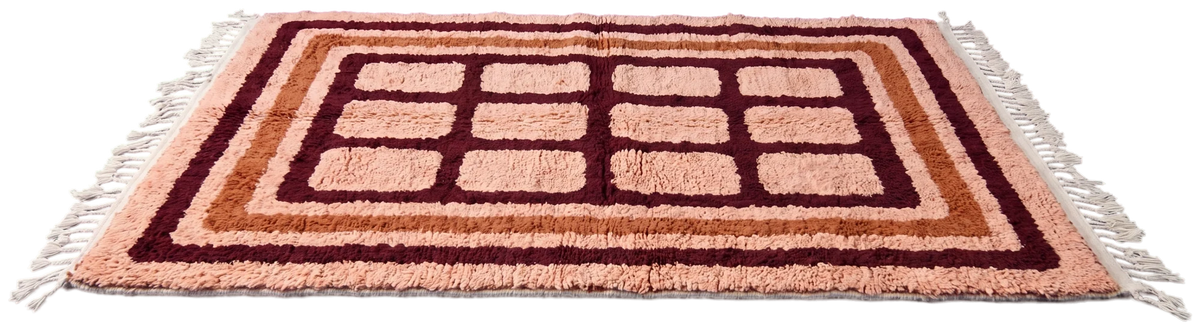 Frame Crossing wool rug with grid lines in oxblood and terracotta on blush, laid flat