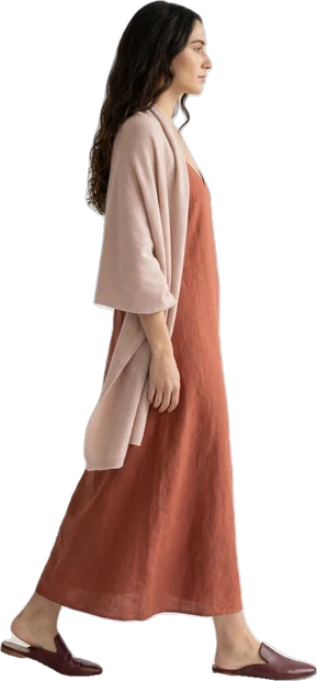 Woman walking: woman with long wavy dark hair walking to the right in side profile
