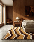 Load image into Gallery viewer, Brown, Cream and Ochre Yellow wavy wool rug in a furnished room
