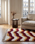 Load image into Gallery viewer, Burgundy, Ochre Yellow and Cream wavy wool rug in a furnished room
