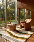 Load image into Gallery viewer, Olive Green, Ochre Yellow and Cream wavy wool rug in a furnished room
