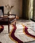 Load image into Gallery viewer, Burgundy, Ochre Yellow and Cream wavy wool rug in a furnished room

