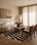 Load image into Gallery viewer, Cream and Dark Brown wavy wool rug in a furnished room

