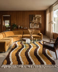 Load image into Gallery viewer, Brown, Cream and Ochre Yellow wavy wool rug in a furnished room
