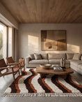 Load image into Gallery viewer, Brown, Terracotta and Cream wavy wool rug in a furnished room
