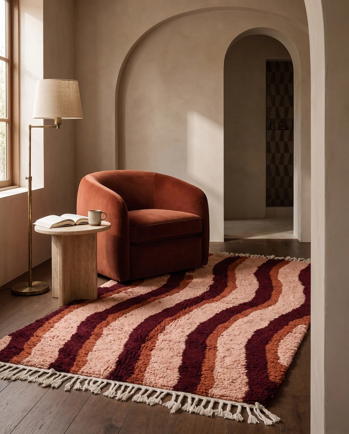 Burgundy, Terracotta and Blush Pink wavy wool rug in a furnished room