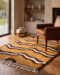 Load image into Gallery viewer, Brown, Cream and Ochre Yellow wavy wool rug in a furnished room
