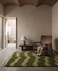 Load image into Gallery viewer, Moss, Sage and Olive Green wavy wool rug in a furnished room
