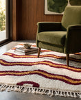 Load image into Gallery viewer, Burgundy, Ochre Yellow and Cream wavy wool rug in a furnished room
