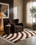 Load image into Gallery viewer, Brown, Terracotta and Cream wavy wool rug in a furnished room
