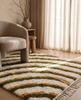 Load image into Gallery viewer, Olive Green, Ochre Yellow and Cream wavy wool rug in a furnished room
