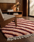 Load image into Gallery viewer, Burgundy, Terracotta and Blush Pink wavy wool rug in a furnished room
