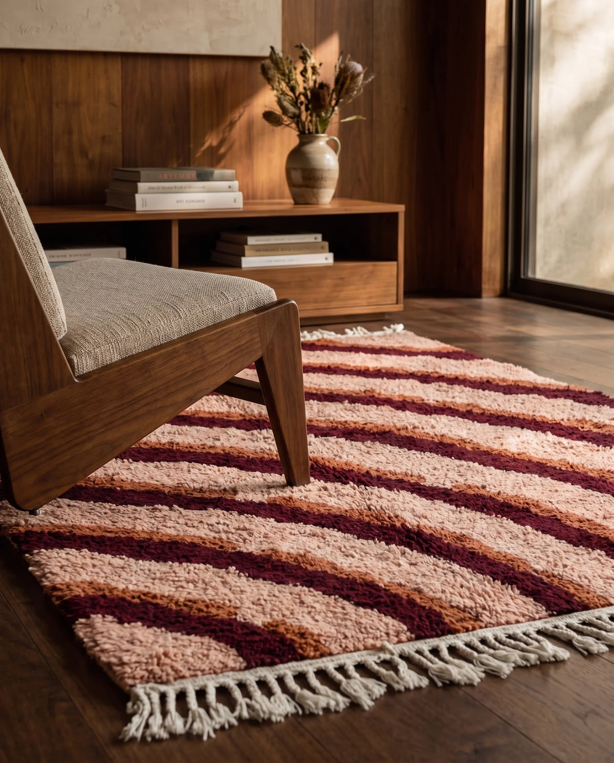 Burgundy, Terracotta and Blush Pink wavy wool rug in a furnished room
