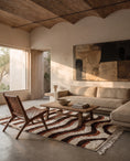 Load image into Gallery viewer, Brown, Terracotta and Cream wavy wool rug in a furnished room
