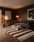 Load image into Gallery viewer, Cream, Ochre Yellow and Dark Brown wavy wool rug in a furnished room
