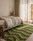 Load image into Gallery viewer, Moss, Sage and Olive Green wavy wool rug in a furnished room
