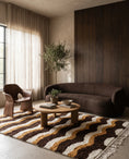 Load image into Gallery viewer, Cream, Ochre Yellow and Dark Brown wavy wool rug in a furnished room
