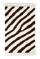 Slant Stride zebra stripe wool rug, dark brown stripes on cream, full view from above with fringed ends