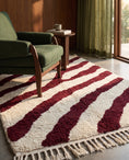 Load image into Gallery viewer, Burgundy and Cream zebra stripe wool rug in a furnished room
