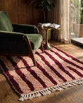 Load image into Gallery viewer, Burgundy and Blush Pink zebra stripe wool rug in a furnished room
