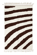 Turning Stride zebra stripe wool rug, dark brown stripes on cream, full view from above with fringed ends